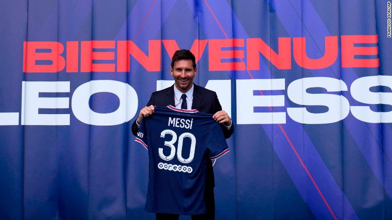 Lionel Messi holds his jersey after a press conference Wednesday, Aug. 11, 2021 at the Parc des Princes stadium in Paris. Lionel Messi said he's been enjoying his time in Paris &quot;since the first minute&quot; after he signed his Paris Saint-Germain contract on Tuesday night. The 34-year-old Argentina star signed a two-year deal with the option for a third season after leaving Barcelona. (AP Photo/Francois Mori)